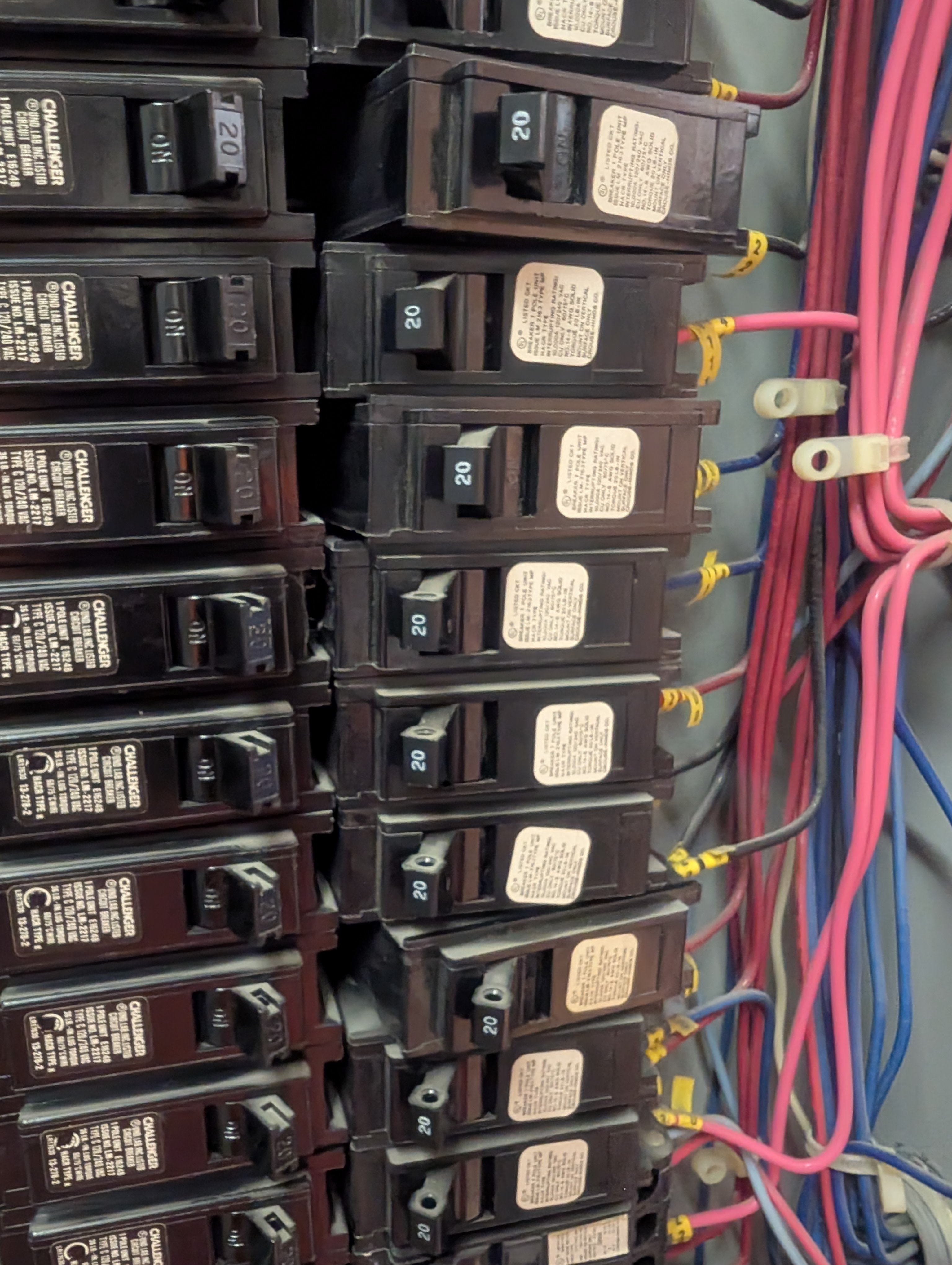 Close view of existing circuit breakers and wiring photographed during a limited electrical evaluation